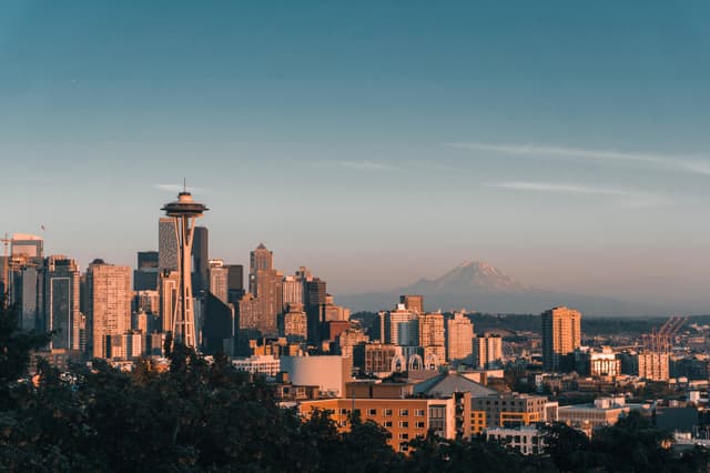 Sunset view of Seattle skyline featuring the Space Needle and distant Mount Rainier